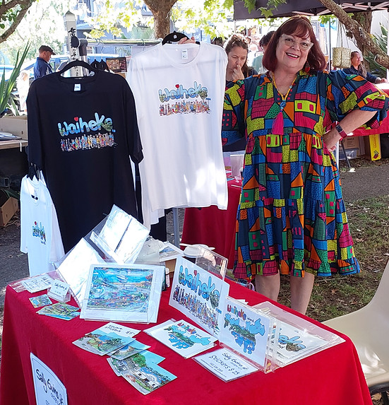 Sally Ewins at a market stall with Louise Wolmernans and Waiheke t-shirts
